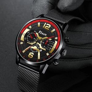 Close-up of black sport watch with metal mesh strap and branded KUN chronograph dial