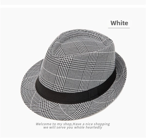 Close-up of classic Fedora hat with black and white plaid pattern and grosgrain ribbon band