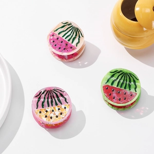 Three fruit-themed acetate hair claws with watermelon patterns on a white background