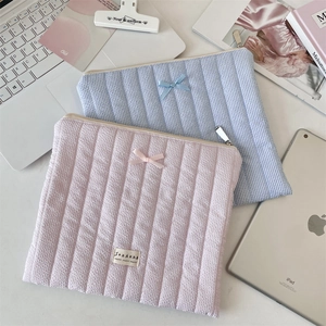 Quilted seersucker laptop sleeves in pink and blue stripes with ribbon bows
