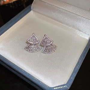 Macro detail of silver needle fan-shaped earrings with sparkling cubic zirconia inlay