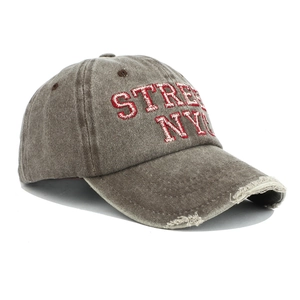 Detail of vintage washed cotton dad hat featuring NYC embroidery and distressed brim details