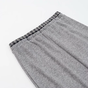 Close-up of gray knit sweatpants waist with checkered elastic band detail