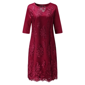 Close-up of wine red lace embroidery and mesh fabric on a stylish A-line dress
