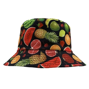 Detailed view of black reversible bucket hat with vibrant all-over fruit pattern print