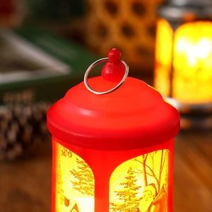 Close-up detail of a red vintage Christmas LED lantern with Santa Claus pattern