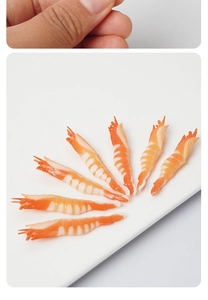 Macro detail of realistic PVC shrimp models showing texture and curved shape for DIY craft