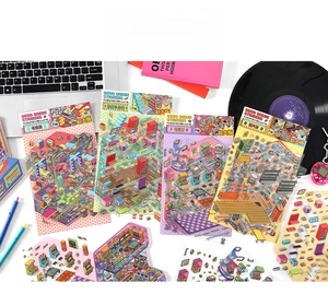 Macro detail of large 2.5D isometric stickers featuring retro game and record store themes