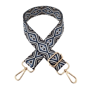 Detail of blue diamond geometric woven strap with gold metal buckles and lobster clasps