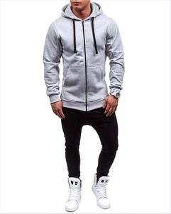 Full view of light grey men's zip-up hoodie with long sleeves on a model in white studio