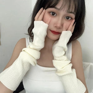 Detail of cream white ribbed knit arm warmers showing thick texture and slouchy style