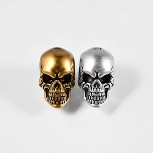 Gothic skull shaped ear weights in gold and silver finish with vintage metal texture