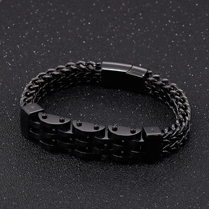 Macro detail of men's double-layer black titanium steel motorcycle chain bracelet