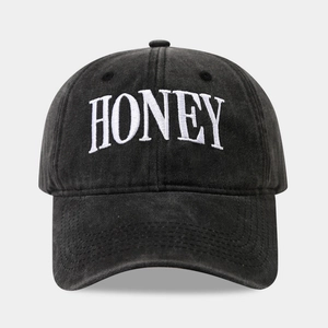 Detailed view of HONEY 3D embroidery on washed cotton fabric of the baseball cap