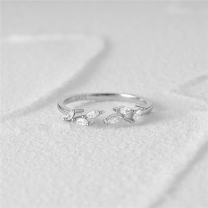 Detailed macro view of S925 sterling silver leaf ring showing hallmarked inner band and zircons
