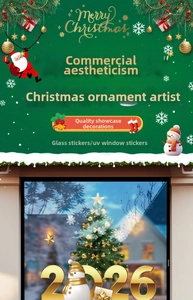 Detailed view of Christmas tree and 2026 gold stickers on commercial glass window