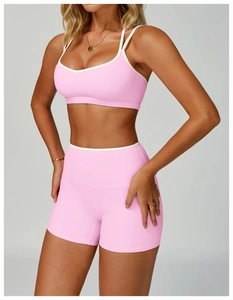 Close-up of pink sports bra and high-waist shorts with contrast white trim