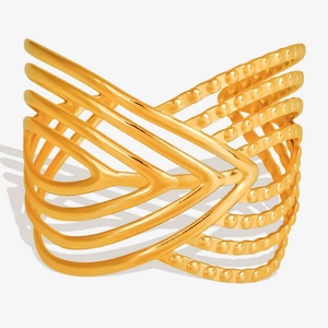 Detail of wide hollow gold stainless steel bangle with beaded and smooth layered lines