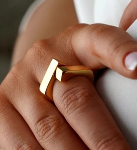 Macro shot of minimalist gold S925 silver geometric cross ring on model finger