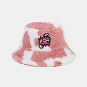 Detailed view of pink and white cow print plush bucket hat with WOW embroidery patch