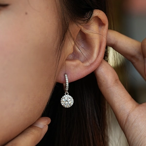 Luxurious S925 sterling silver moissanite halo drop earrings worn by a model