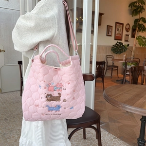 Detail of pink quilted tote bag with cute cat embroidery and adjustable strap