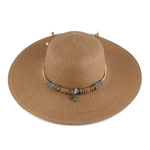 Women's wide brim straw sun hat with woven blue band and bronze starfish pendant charm