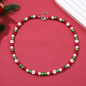 Detailed view of Christmas pearl necklace with red, green and gold heart beads