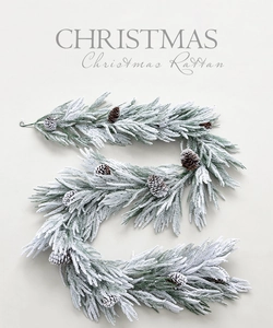 Detailed view of snow-flocked Christmas rattan with natural pine cones and green needles