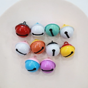 Colorful 2.2cm metal bells for DIY crafts and keychains displayed on a round plate