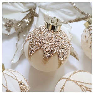 Close-up of velvet Christmas ornament with white pearls, crystals and gold glitter details