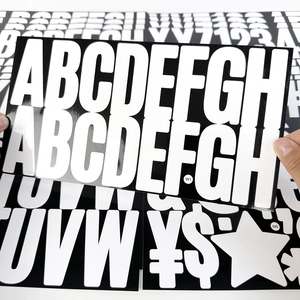 Macro detail of large 2.5-inch self-adhesive black letter stickers with white characters