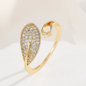 Detailed macro of leaf shaped ring with sparkling cubic zirconia in 18K gold finish