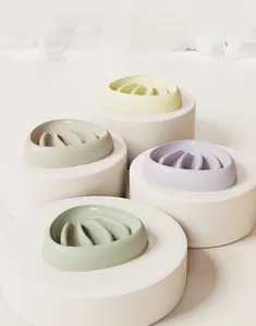 Detail view of shell-patterned slow feeder pet bowls in four pastel Morandi colors