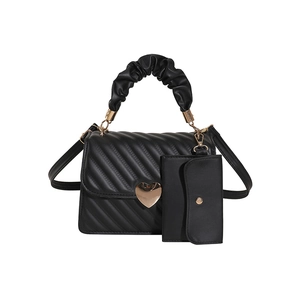 Black pleated tote bag with heart buckle and cloud handle on white background