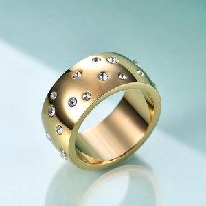 Macro shot of 10mm gold stainless steel ring with scattered round white crystals