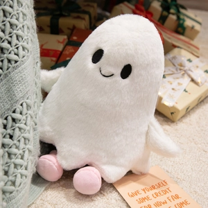 Close-up of cute white plush ghost toy with soft pink feet and black embroidered eyes