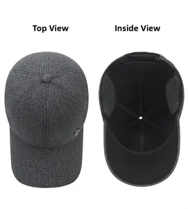 Macro view of grey woolen baseball cap showing top panel seams and warm ear protection lining