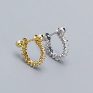 Detailed view of s925 silver hoop earrings with glittering cubic zirconia in gold and silver