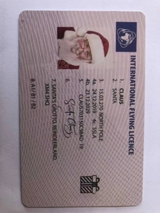 Macro shot of novelty Santa Claus international flying licence with north pole details