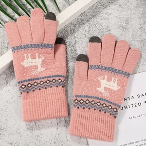 Close-up of pink knit gloves with touchscreen tips and white reindeer pattern