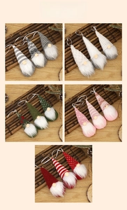 Detail view of colorful knitted Christmas gnome hanging ornaments in five color sets