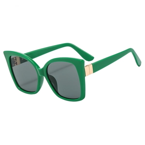 Modern green cat-eye sunglasses with gray lenses and golden metal hinge details