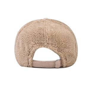 Close-up of beige sherpa baseball cap back with brown corduroy strap and metal buckle