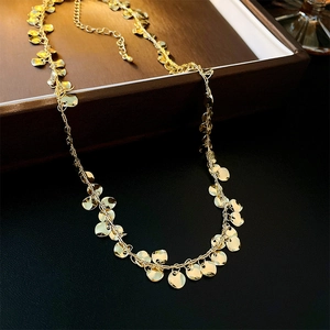 Detail shot of golden sequin choker with round metal discs and adjustable lobster clasp