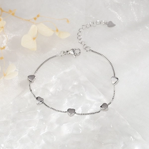 Detailed macro view of S925 silver heart bracelet with polished box chain and secure lobster clasp