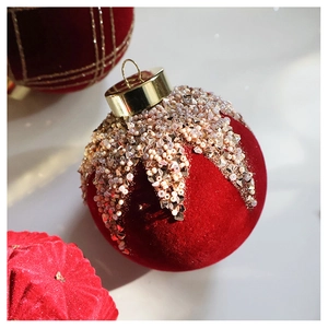 Close-up of velvet Christmas ball with gold metal cap and sequin beaded crown detailing