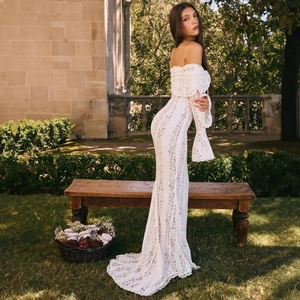 Detail of off-shoulder lace dress with flare sleeves and elegant mermaid fish-tail hem