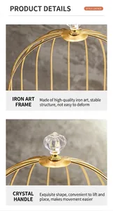 Detail of golden iron birdcage organizer featuring a crystal handle and sturdy metal frame