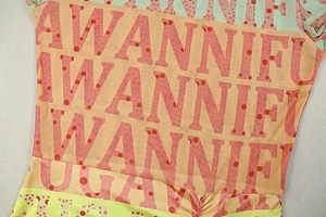 Detail of breathable mesh fabric featuring vibrant geometric prints and letter patterns